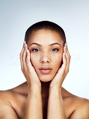 Buy stock photo Shot of a beautiful young woman touching her face against a grey background