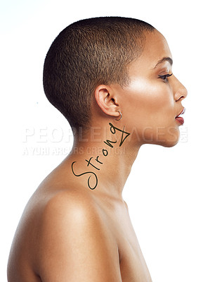 Buy stock photo Profile shot of a beautiful young woman with the word strong written on her neck