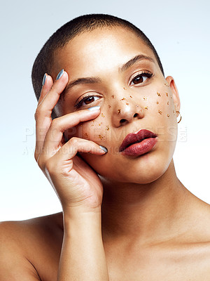 Buy stock photo Studio shot of a beautiful young woman posing with glitter freckles on her face