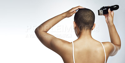 Buy stock photo Rearview shot of a young woman shaving her head against a white background