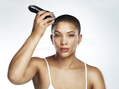 Buy stock photo Studio shot of a beautiful young woman shaving her head against a grey background