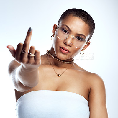 Buy stock photo Studio shot of a beautiful young woman showing middle finger against a grey background