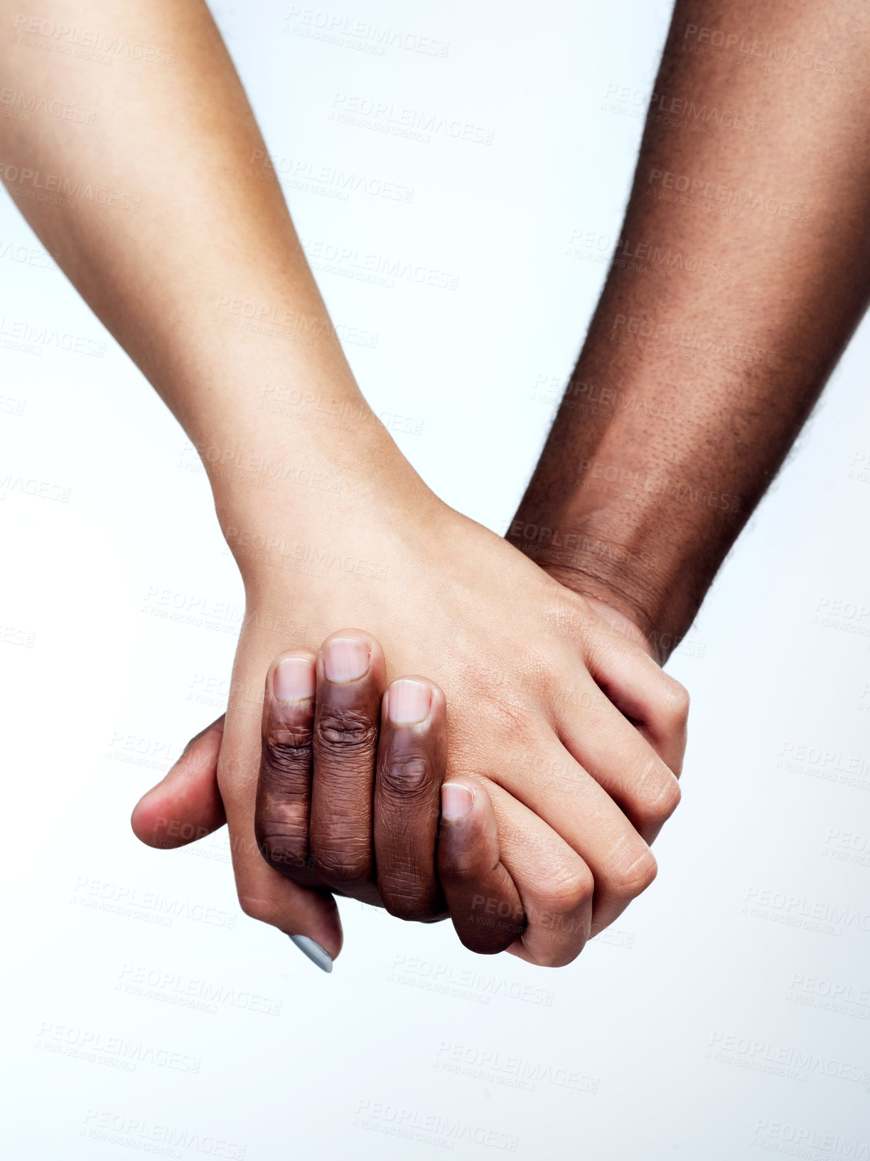 Buy stock photo Studio shot of two unrecognizable people holding hands against a grey background