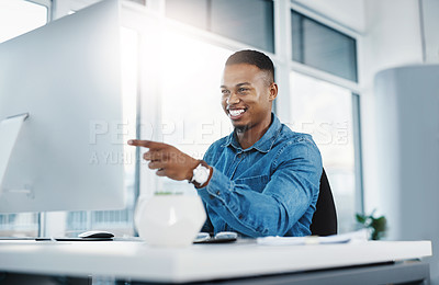 Buy stock photo Happy, pointing and black man by computer in office, workspace and desk confident in creative career. professional, internship and journalist with technology for typing, research and internet