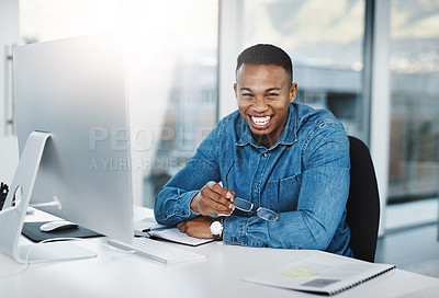 Buy stock photo Portrait, happiness and black man in modern office with laptop, paperwork and laugh at desk. Businessman, smile and technology in workplace for internship, journalist and online streaming or research