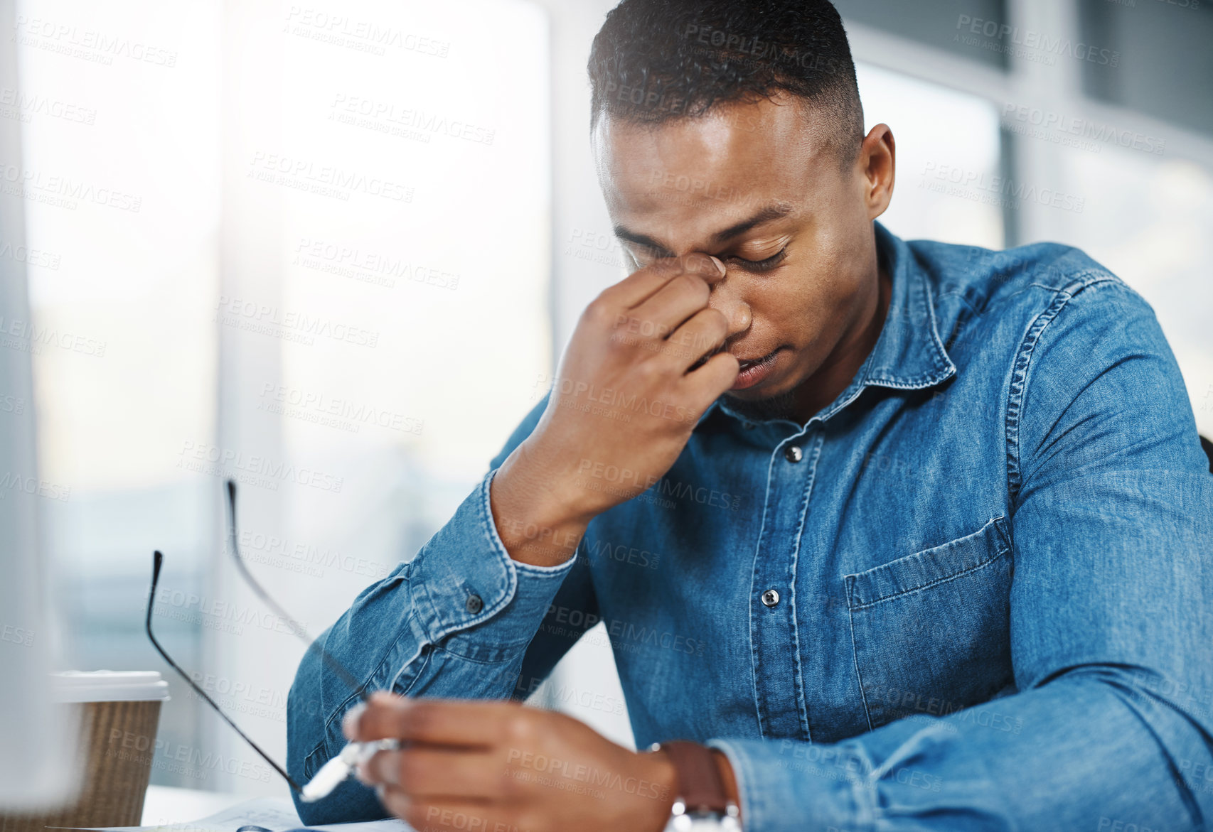Buy stock photo Business, headache and black man in office for stress, marketing error or mistake on project. Anxiety, lens flare and graphic designer at desk for migraine, work crisis or burnout in workplace