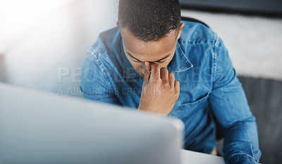 Buy stock photo High angle shot of a young businessman looking highly stressed at work