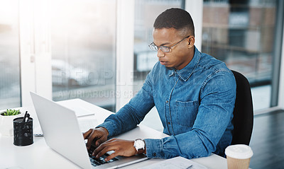 Buy stock photo Typing, serious and black man by computer in office, workspace or desk professional in creative career. Email, internship or journalist with technology for productivity, research or internet