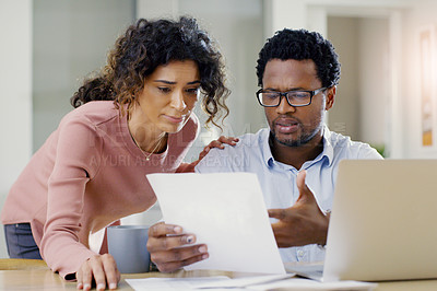 Buy stock photo Couple, document and finance for debt, bills or planning expenses together in the kitchen at home. Serious African man and woman working on paperwork in financial crisis, mortgage or investment plan