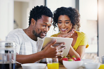 Buy stock photo Online, morning and breakfast with couple and tablet for social media, news and app. Happy, love and smile with man and woman browsing together at home for internet, technology and communication