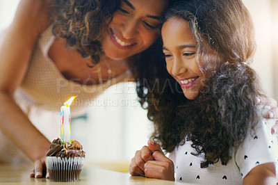Buy stock photo Shot of a young mother and daughter celebrating a birthday at home