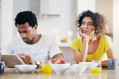 Buy stock photo Technology, breakfast and man ignore woman for social media, reading news and digital app in morning. Marriage, couple and sad female and male on tablet with relationship problem, ignoring and issues