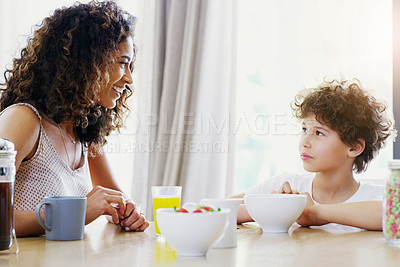 Buy stock photo Family, breakfast and kid with mother at morning in a home with happiness and orange juice with care. Mom, food and young child together with love and support with healthy drink and youth with smile