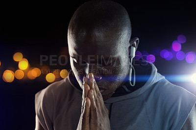 Buy stock photo Black man, athlete and praying hands for sports exercise at night with bokeh for competition, hope or dark background. Male person, earphones and workout training for marathon run, belief or fitness