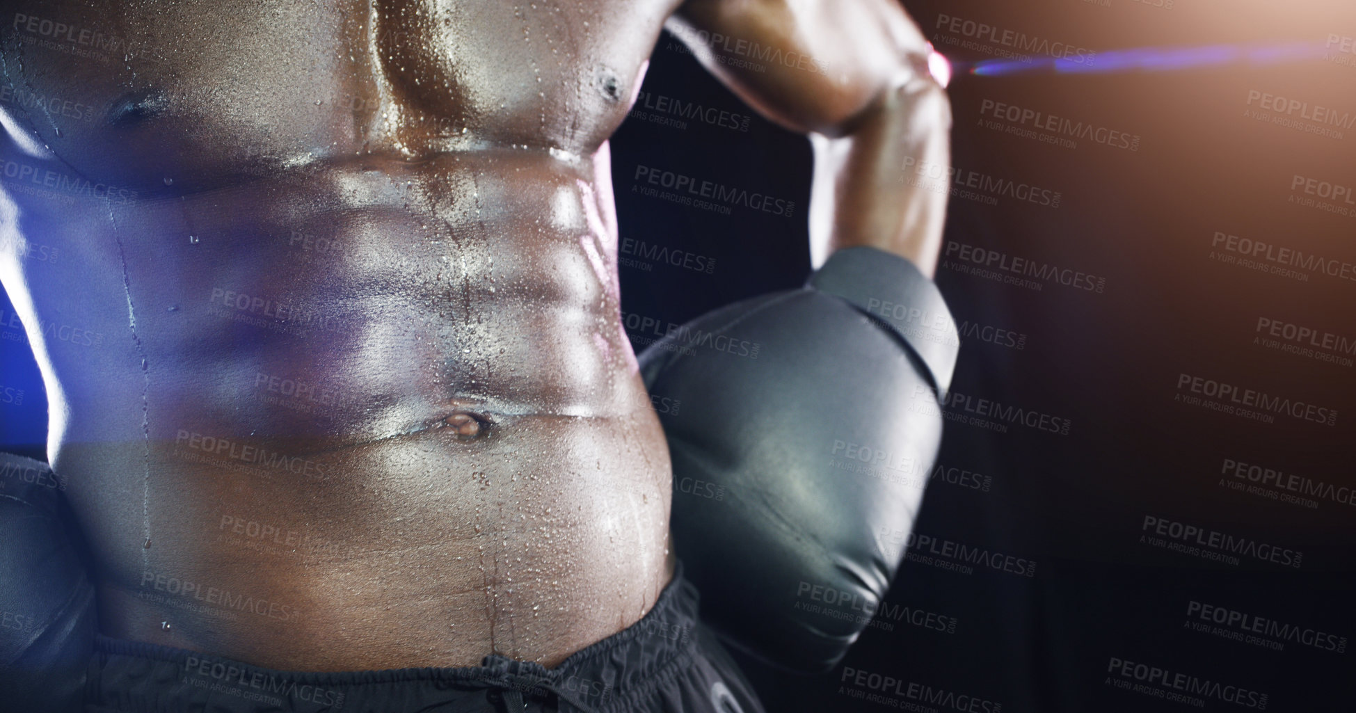 Buy stock photo Studio shot of an unrecognizable shirtless sportsman posing against a dark background