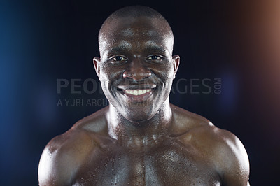 Buy stock photo Studio shot of a young sportsman posing against a dark background