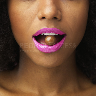 Buy stock photo Shot of an unrecognizable woman posing with a chocolate ball in her mouth