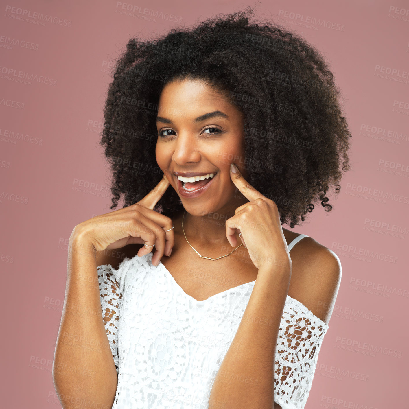 Buy stock photo Shot of a beautiful young woman posing with her fingers on her cheeks