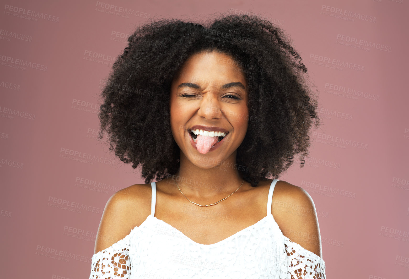 Buy stock photo Funny face, comic and tongue with woman in studio on pink background feeling silly or goofy. Comedy, joke and crazy with black girl looking playful and having fun or joking isolated with emoji