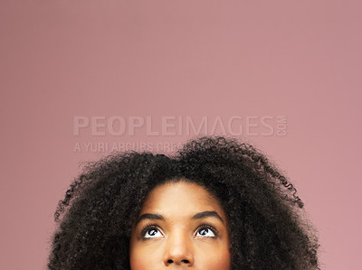 Buy stock photo Cropped shot of a beautiful young woman looking up at empty copy-space