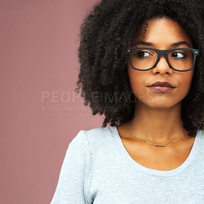 Buy stock photo Studio shot of an attractive young woman looking away seriously against a pink background