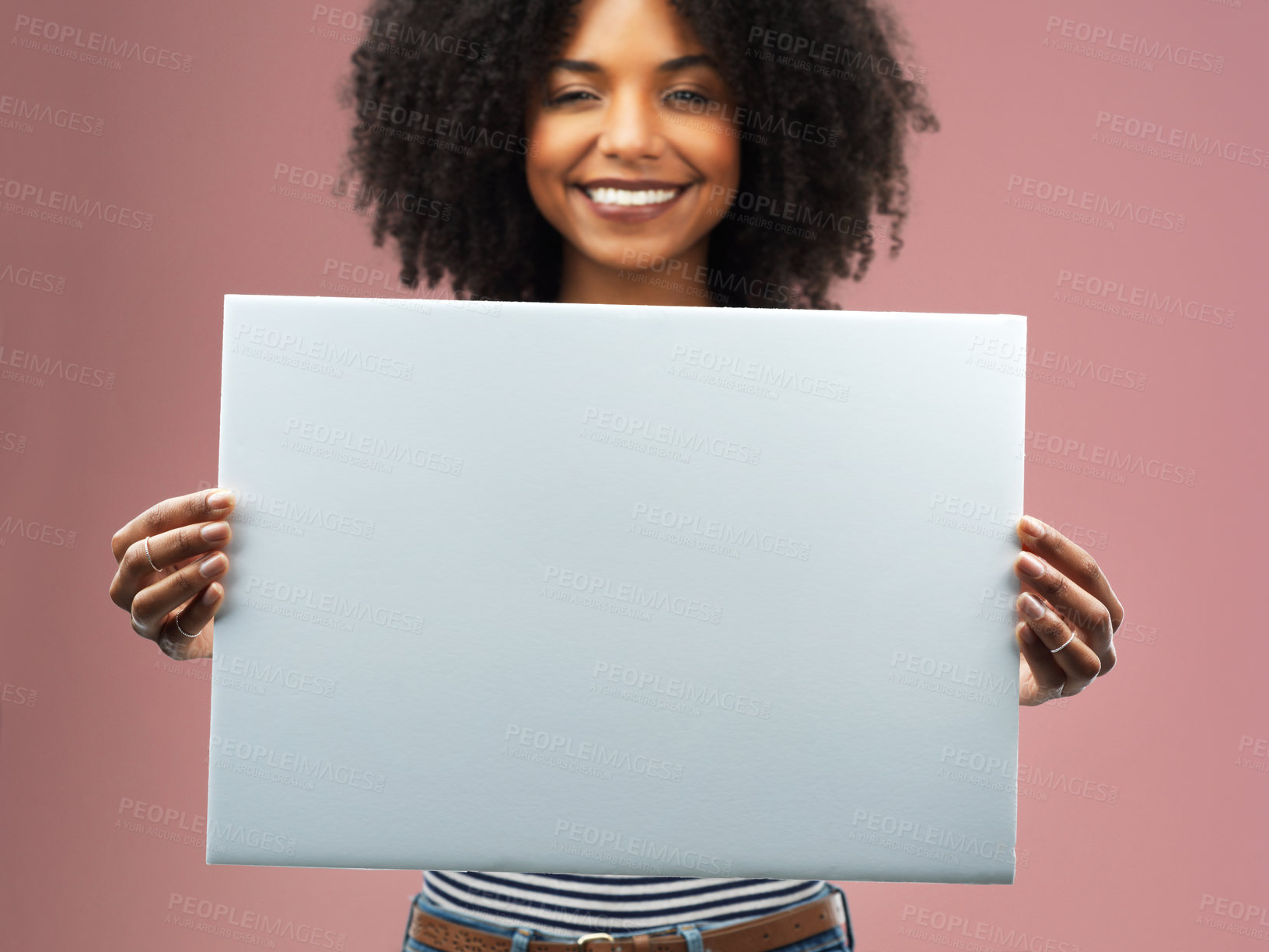 Buy stock photo Studio shot of an attractive young woman holding a blank placard against a pink background