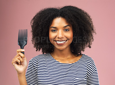 Buy stock photo Studio shot of a beautiful young woman holding up an afro comb