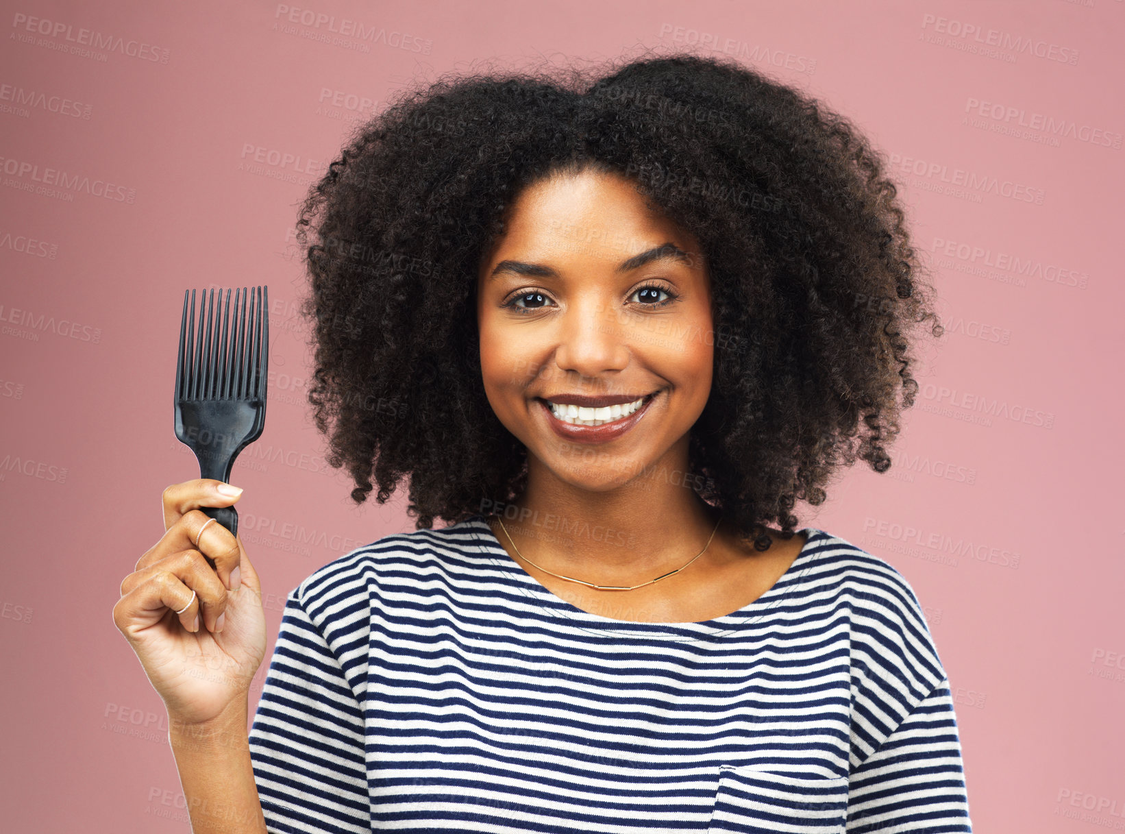 Buy stock photo Studio shot of a beautiful young woman holding up an afro comb