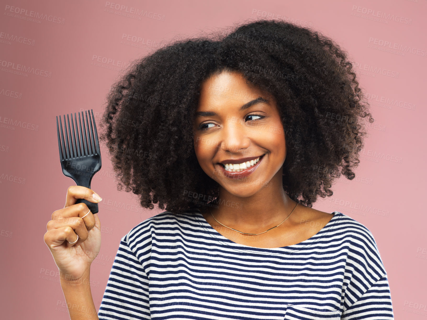 Buy stock photo Afro, haircare and smile of black woman, comb and routine for hairstyle, texture and health of hair. Pink background, morning and African girl with happiness for treatment in studio and hairdresser