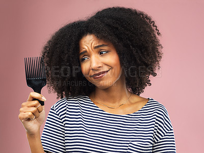 Buy stock photo Comb, afro and black woman with stress for damage, natural haircare fail and fear for hair loss in studio. Doubt, African girl and cosmetic tool with frizz texture for scalp crisis by pink background