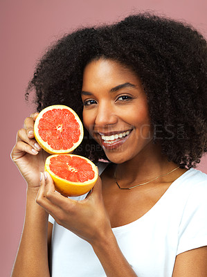 Buy stock photo Grapefruit, happy and portrait of woman in studio isolated on a pink background, citrus detox or natural wellness. Face, fruits and african female model with vegan beauty, vitamin c and healthy diet