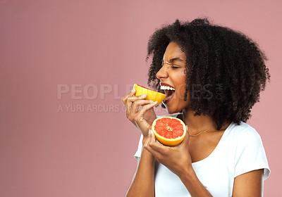 Buy stock photo Happy, woman and eating fruit for health, balanced diet and nutrition with vitamin c and mockup space. Excited, black person and organic food for detox, vegan option and wellness on pink background