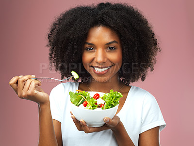 Buy stock photo Portrait, eating and woman with salad for wellness, fresh and detox lunch meal with vegetables. Smile, healthy and female person enjoying nutrition, vegan and organic diet food by studio background.