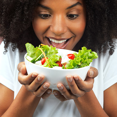 Buy stock photo Health, salad and excited with black woman in studio eating vegetables for nutrition or vegan diet. Girl, pink background and happy for food, detox and wellness benefits for weight loss and joy