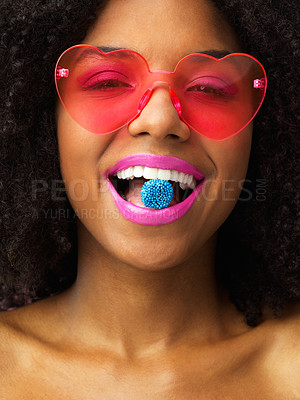 Buy stock photo Candy, portrait and woman in studio with retro fashion, heart glasses or afro in close up. Quirky, makeup and female person with bright lips, smile or fun eyewear for cosmetics or accessories