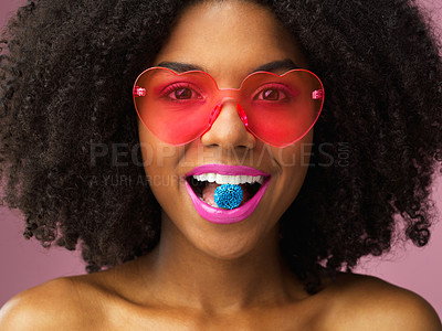 Buy stock photo Portrait, candy and woman in studio with retro fashion, heart glasses or afro on pink background. Quirky, makeup and female person with bright lips, smile or fun eyewear for cosmetics or accessories