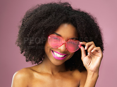 Buy stock photo Studio shot of an attractive young woman wearing heart shaped sunglasses against a pink background