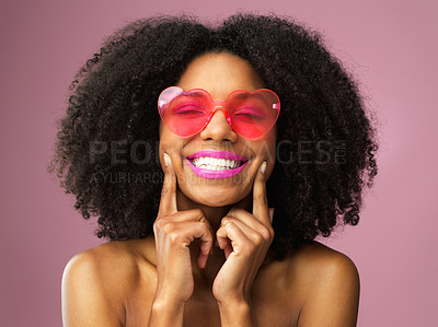 Buy stock photo Girl, smile and heart sunglasses in studio with confidence for fashion, style and trendy black person. Woman, happiness and shades on pink background for summer, beauty and brand with cool glasses