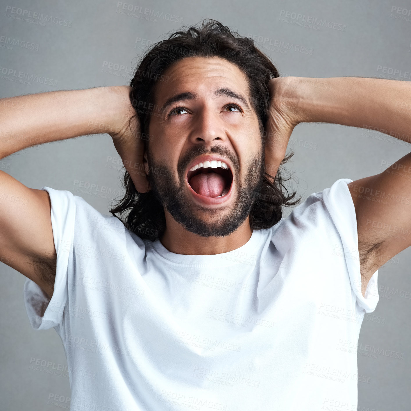 Buy stock photo Frustrated, man and ear with shouting in studio for sensory overload, stress and sensitive to noise. Autism, spectrum and angry person with scream for anxiety, panic and ptsd on gray background