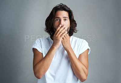 Buy stock photo Studio shot of a handsome young man looking shock against a grey background