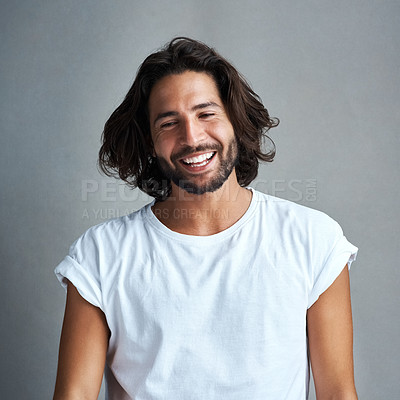Buy stock photo Studio shot of a handsome young man posing against a grey background