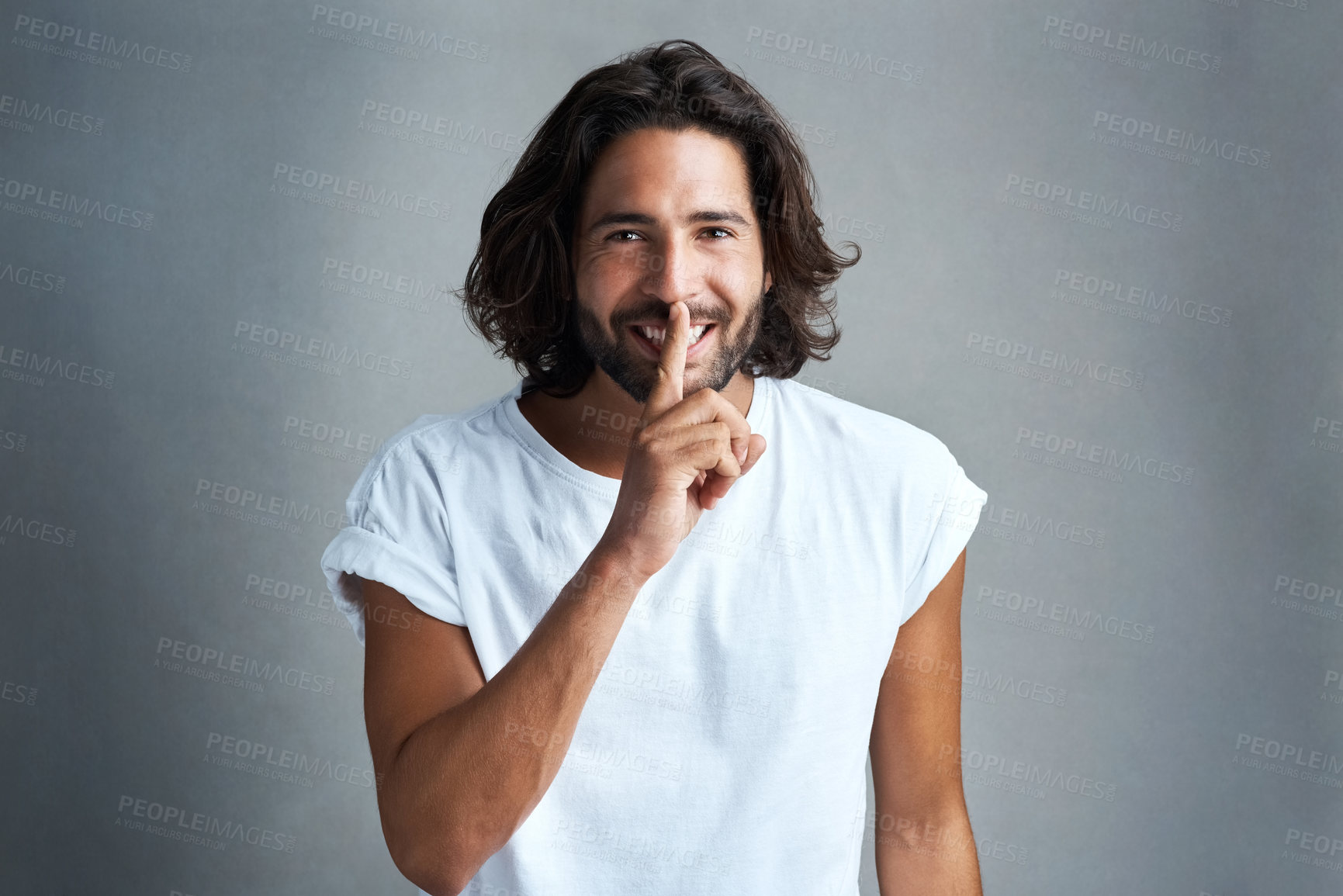 Buy stock photo Portrait, hand on lips and man in studio for secret, gossip or quiet on gray background. Communication, whisper and male model with hush for privacy, confidential information or silence gesture