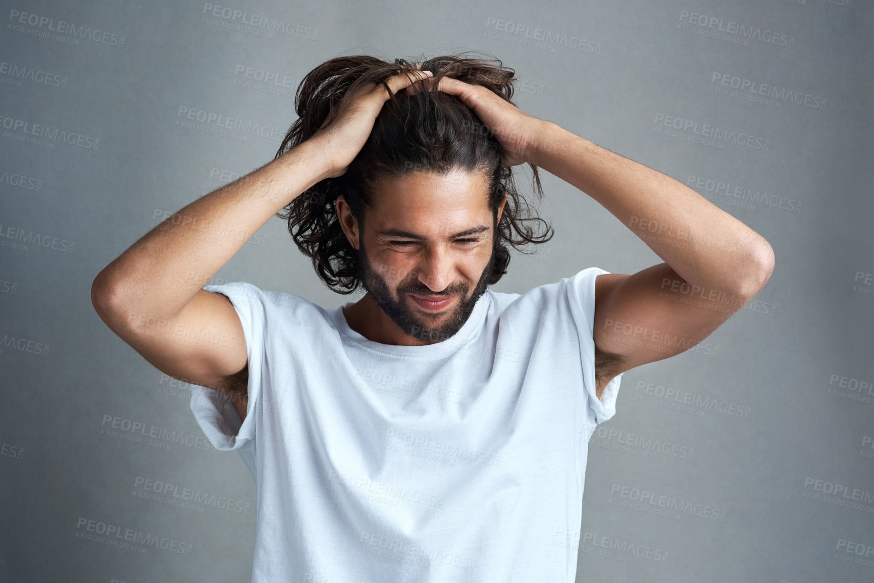 Buy stock photo Studio shot of a young man looking frustrated against a grey background