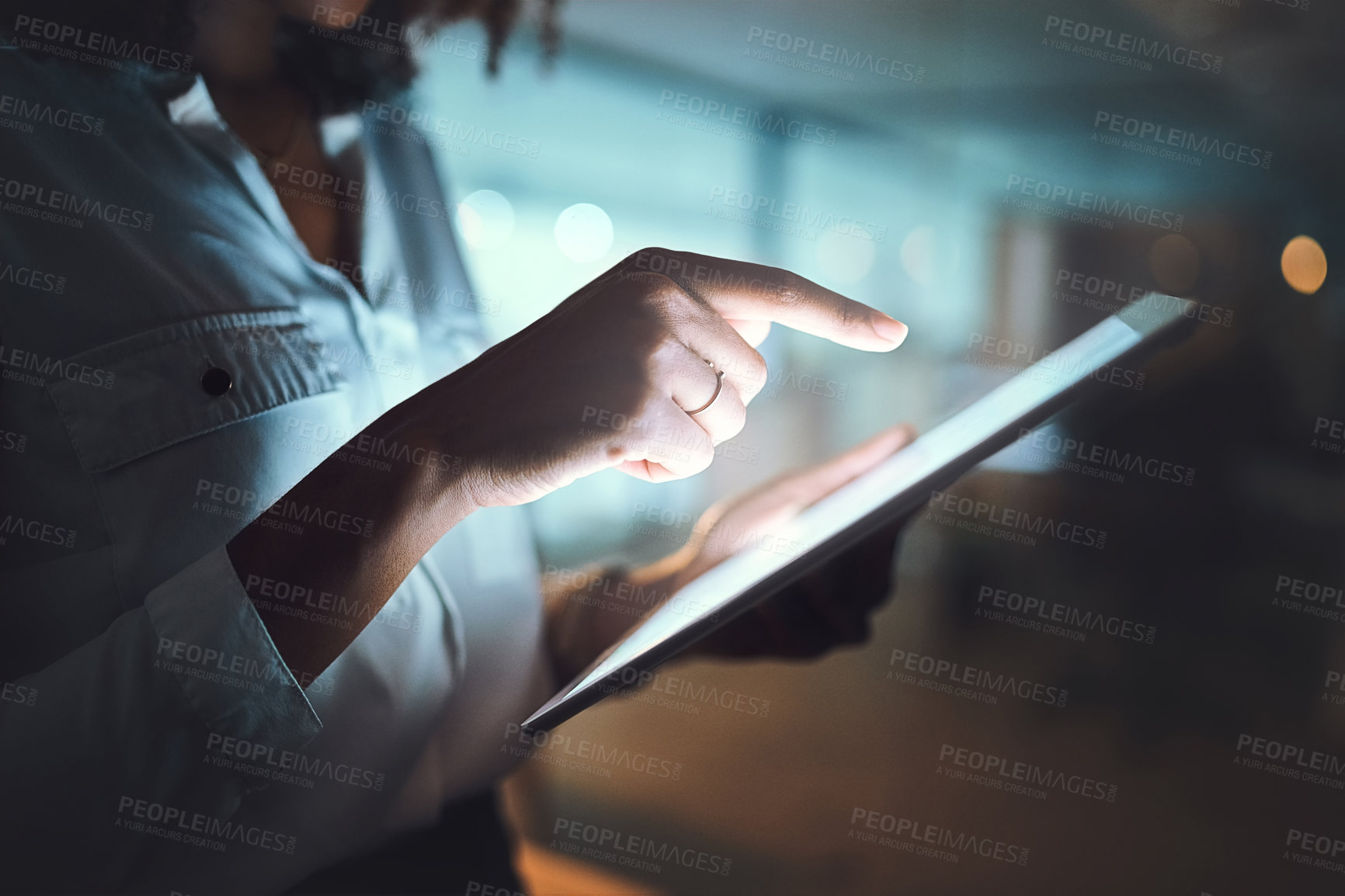 Buy stock photo Closeup shot of an unrecognizable businesswoman using a digital tablet in an office at night