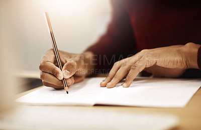 Buy stock photo Closeup shot of a university student writing notes in his book