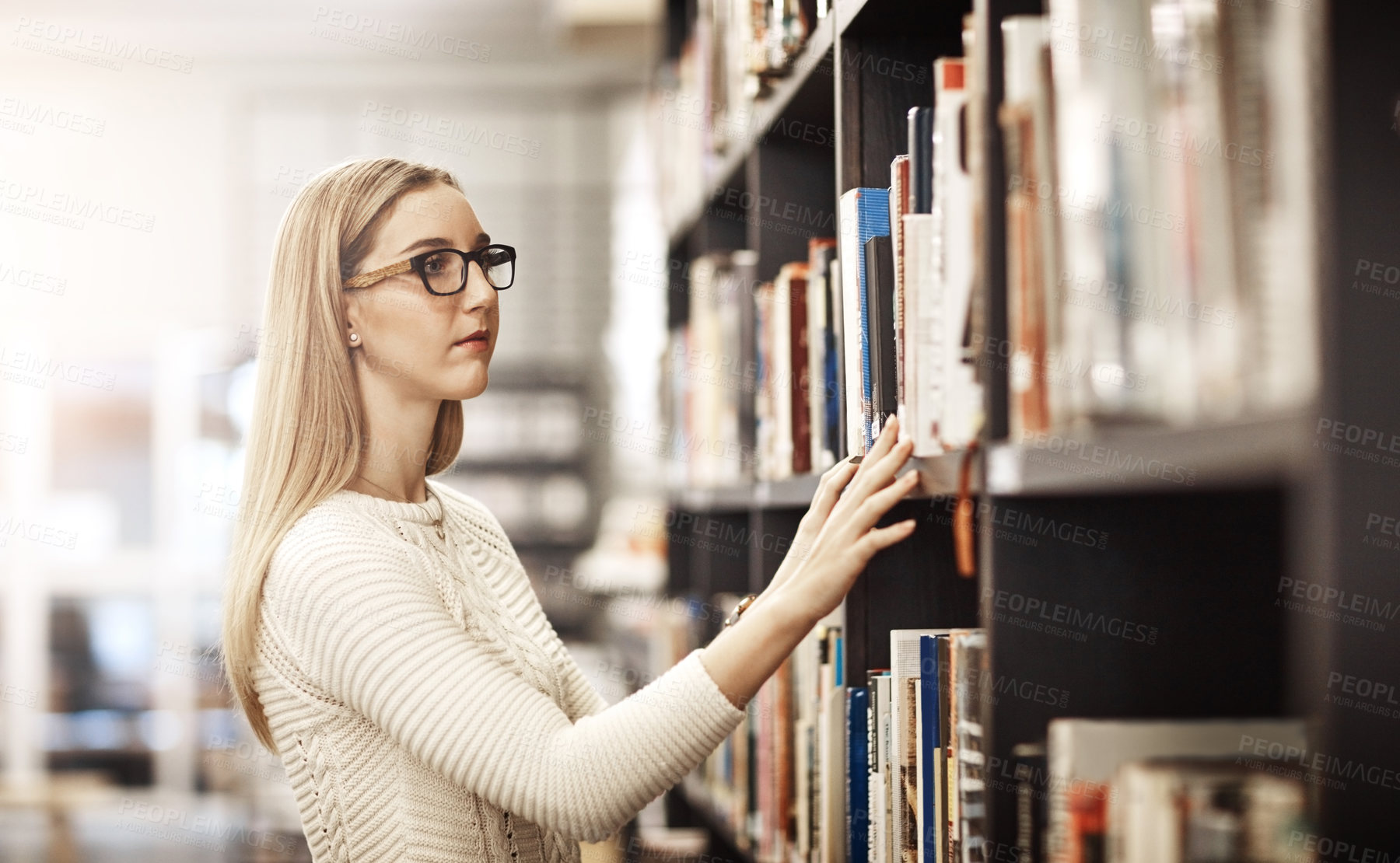 Buy stock photo Library, college student and woman looking for book for education, learning and studying at academy. Bookshelf, school or smart girl at university campus for research, course knowledge or scholarship