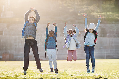 Buy stock photo Full length portrait of a group of elementary school kids jumping outside