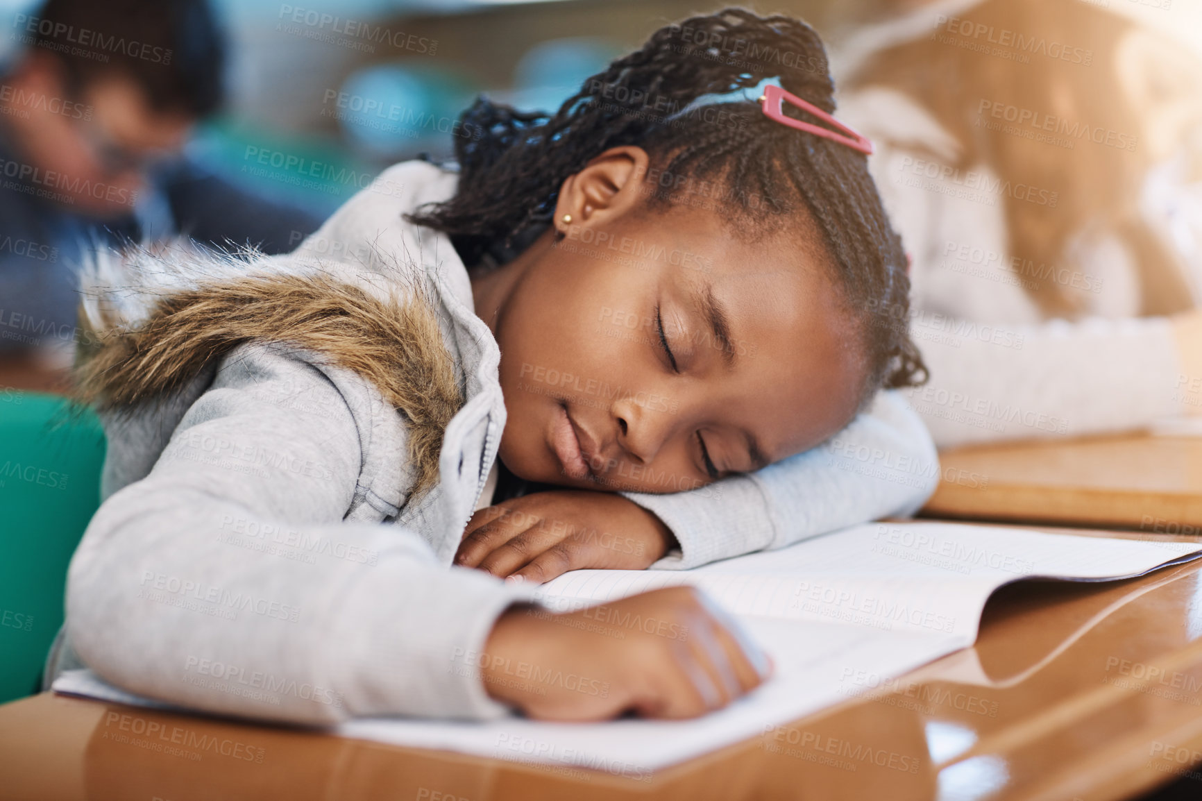 Buy stock photo Cropped shot of an elementary school girl taking a nap in the classroom