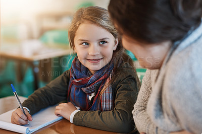 Buy stock photo Cropped shot of an elementary school girl getting help from her teacher in the classroom