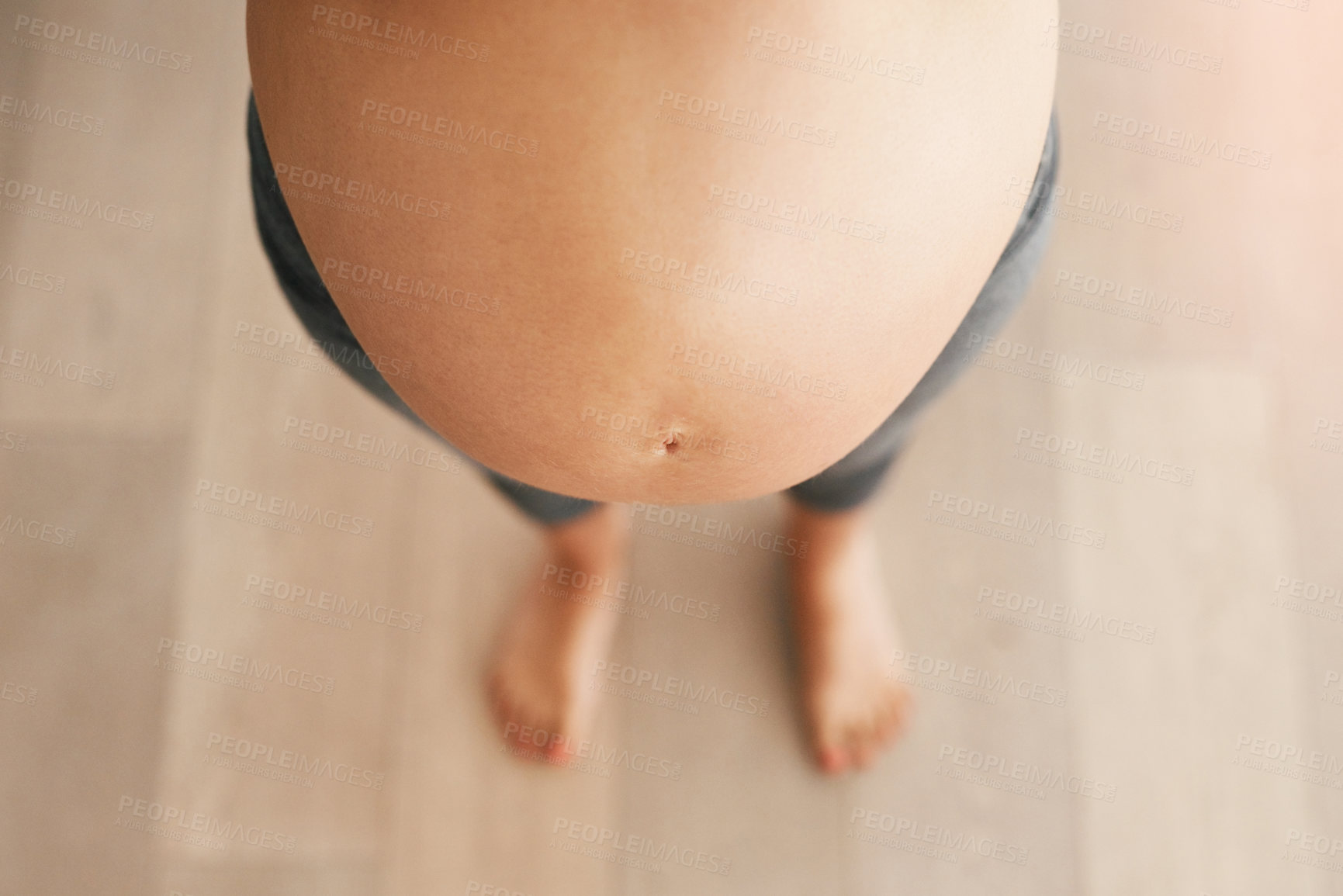 Buy stock photo Above, pregnant woman and standing in home with stomach on maternity break and leave to rest. Female person, mother and belly or baby bump with love, bonding and care for unborn child with growth